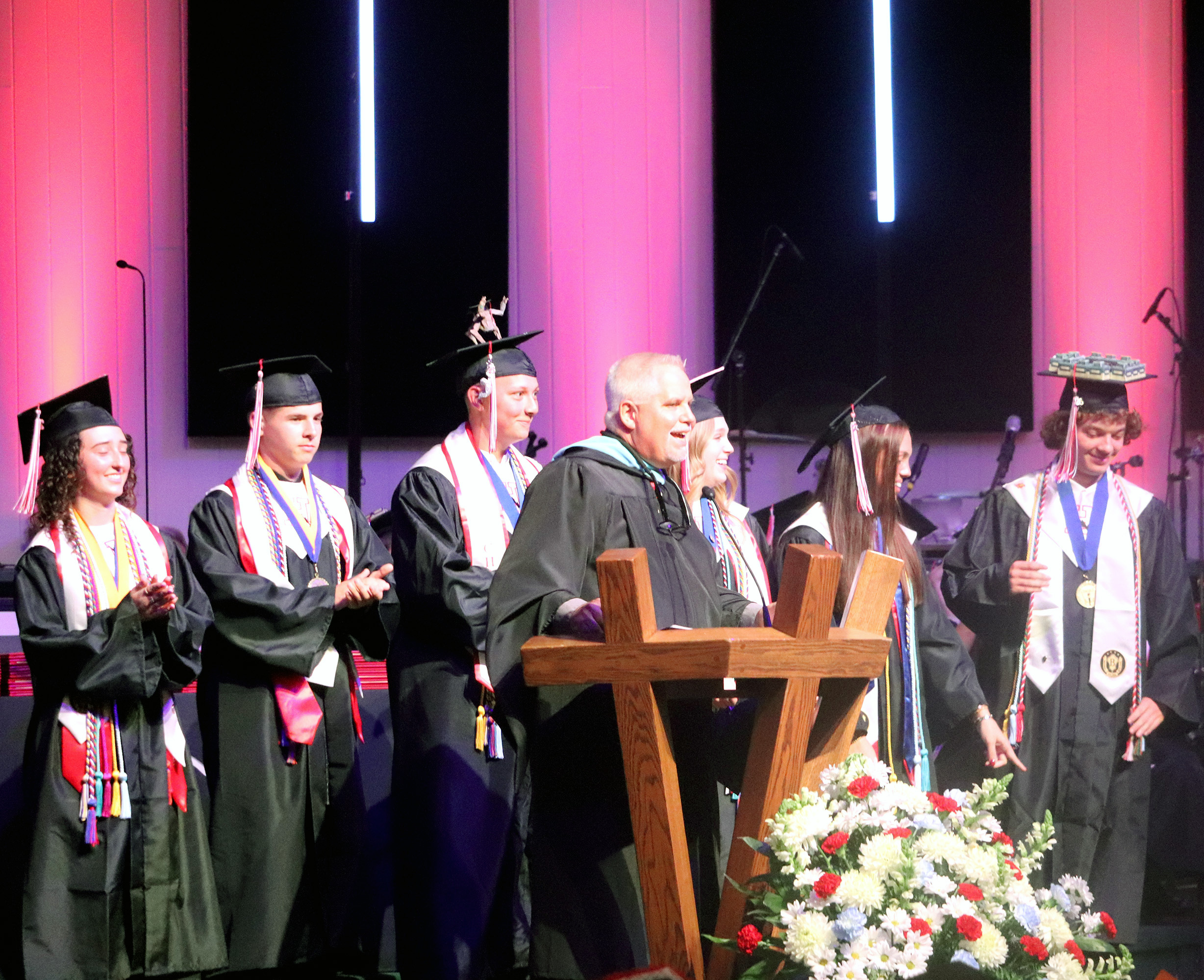 Joined by senior class officers on stage, Principal John Crawford speaks at graduation Thursday. 
