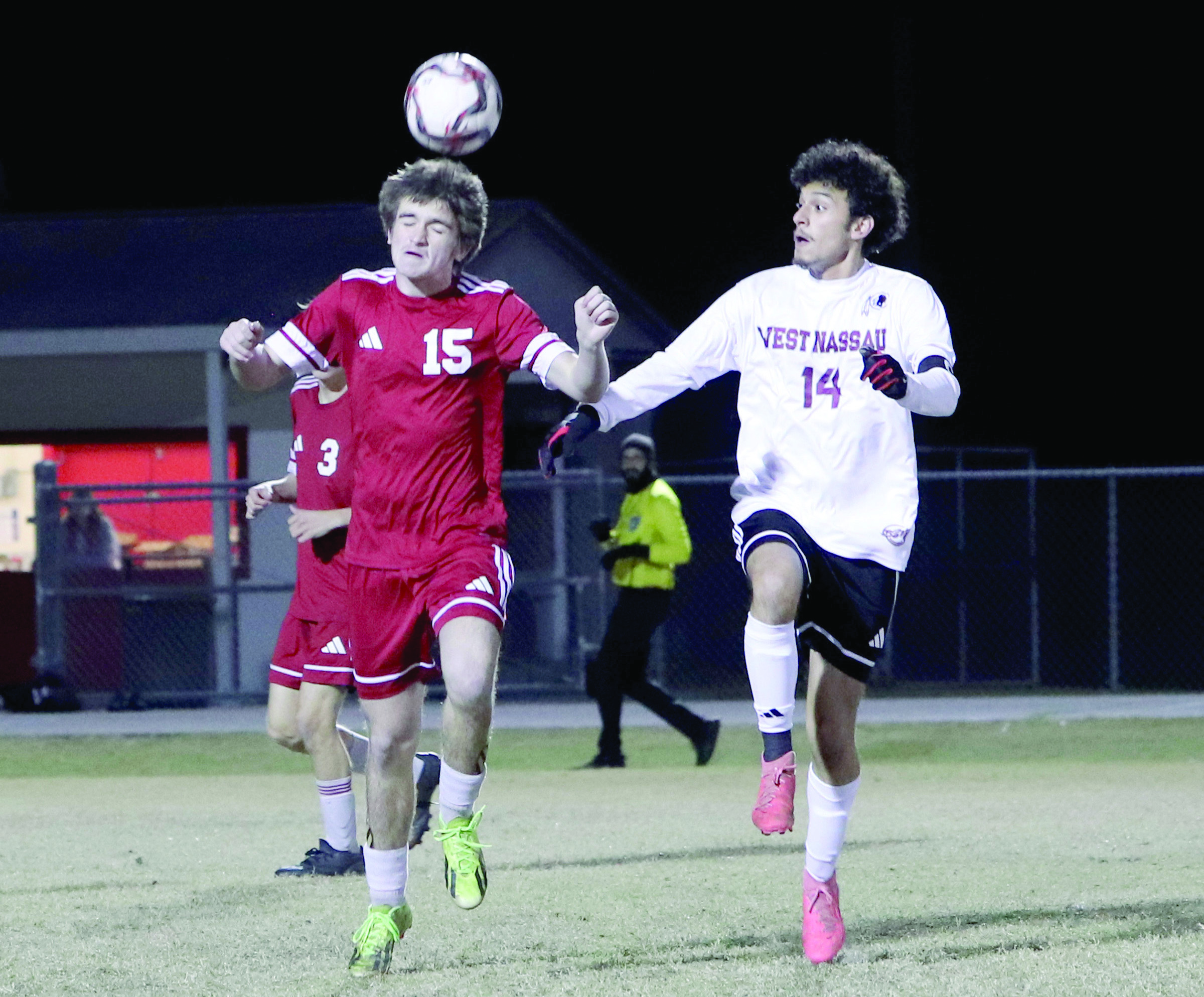 Hilliard soccer player Clayton Floyd hits a header with Warrior David Ortega nearby in December. 