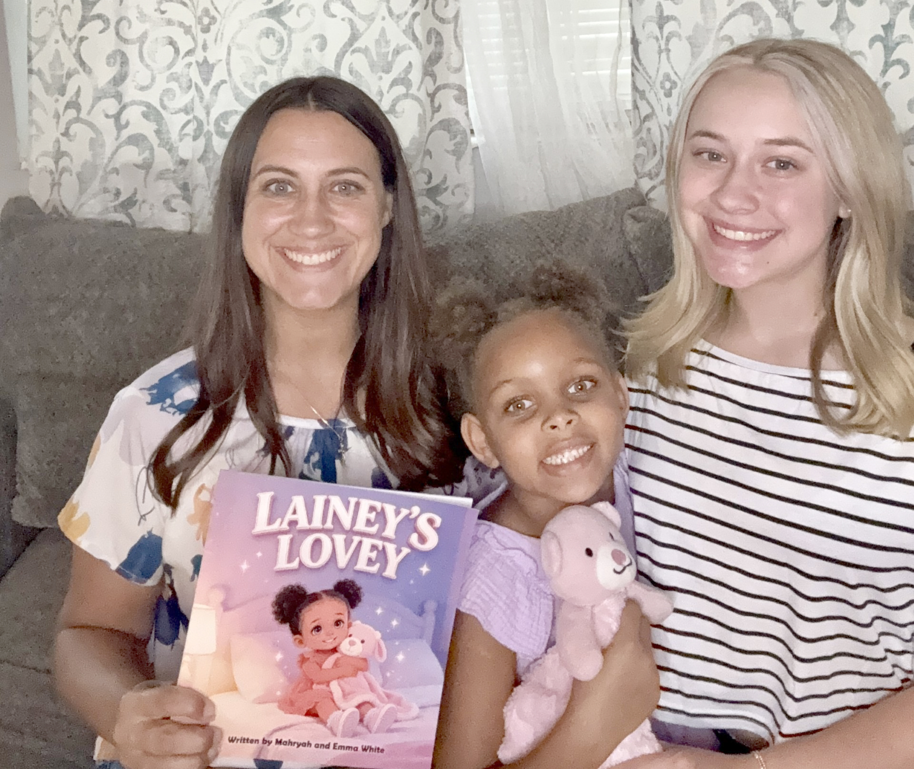 Mahryah, Lainey, and Emma White pose with “Lainey’s Lovey” and the lovey that comforts Lainey, now 6. She was the inspiration for the book about children in foster care. Submitted