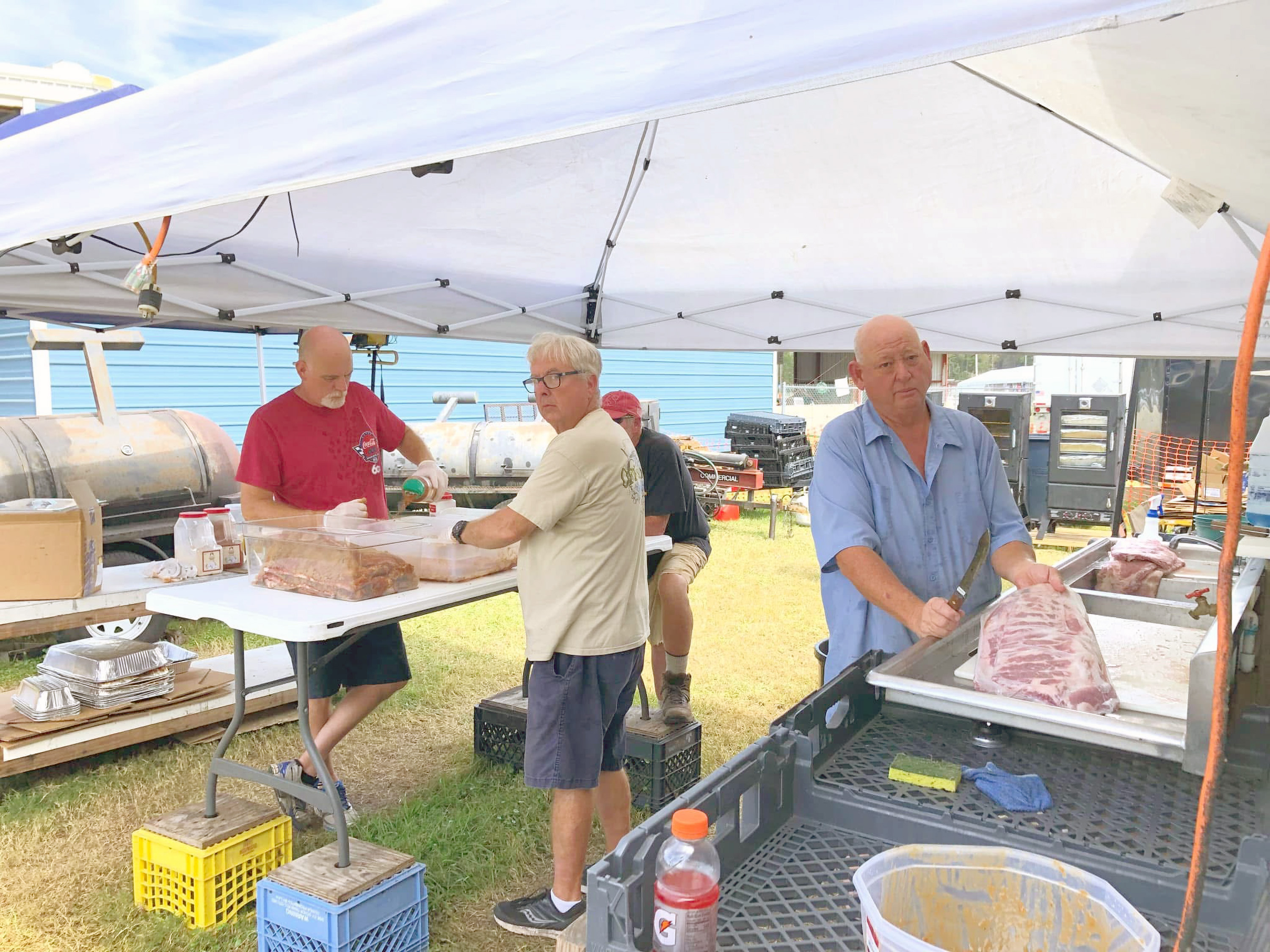 After nearly 20 years of operation, the West Nassau Band Boosters have shut down the annual barbecue food booth at the Northeast Florida Fair. Longtime volunteer Keith Hailey, far right, has been with the booth since day one and enjoyed helping contribute toward the student musicians’ success. Submitted