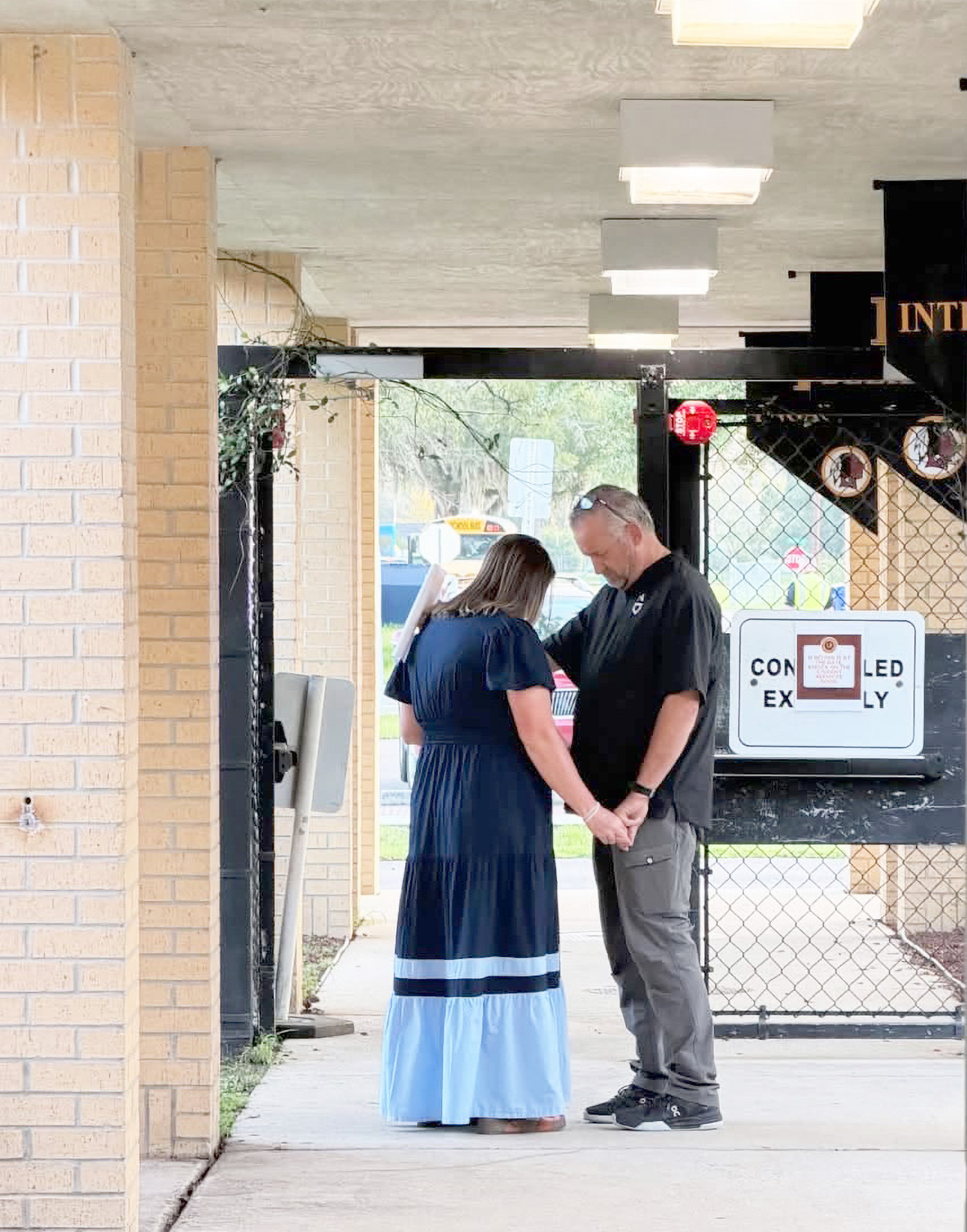 West Nassau Principal Melissa Johnson joins in to pray over West Nassau High School, students, and staff. Submitted