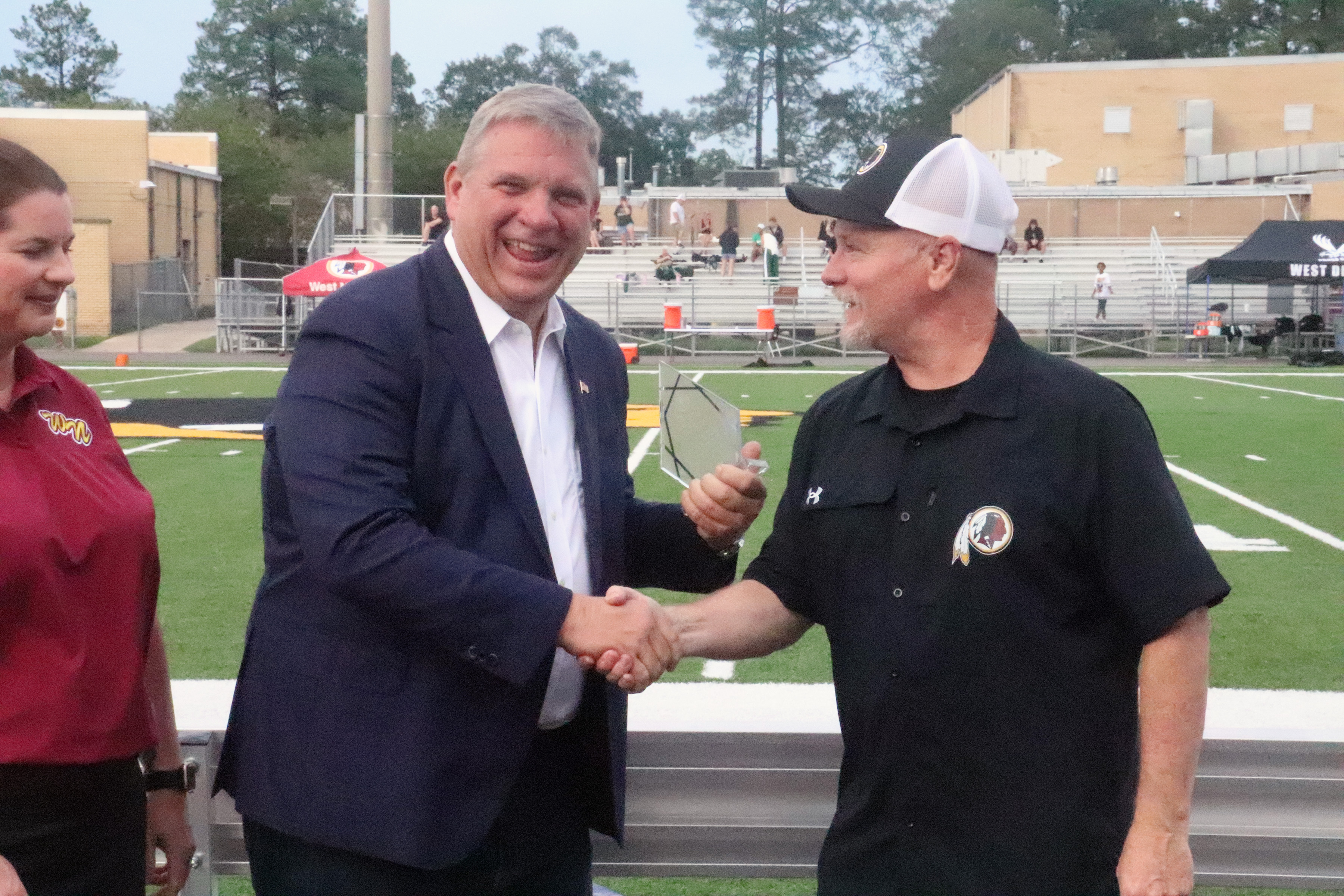 Craig Smith shakes West Nassau High School Athletic Director Richie Knott’s hand Saturday as he’s inducted into the school’s Hall of Fame. 