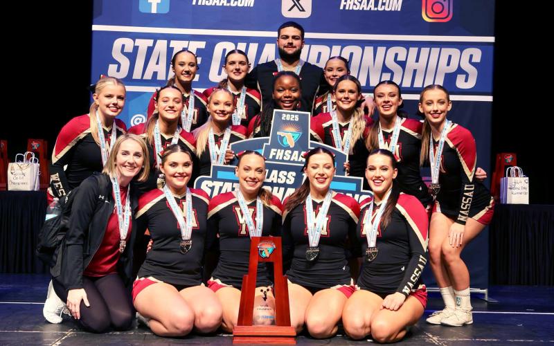 The West Nassau High School cheerleaders display the school’s 14th state championship trophy. The team won first place in the Florida High School Athletic Association Class 1A Medium Non-Tumbling Jan. 31.