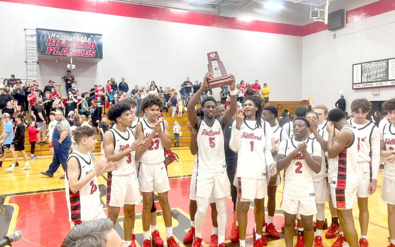 The Flashes celebrate with their district championship trophy.