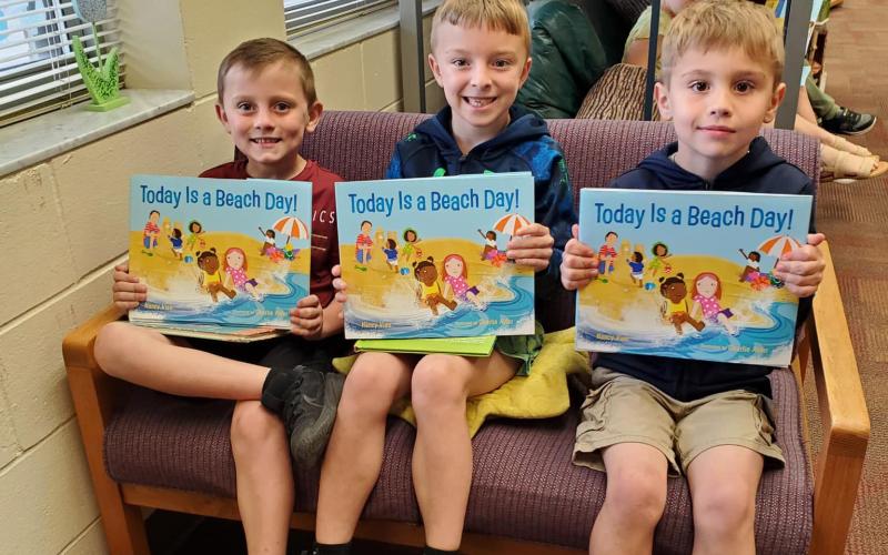 Callahan Elementary School students display books they received.