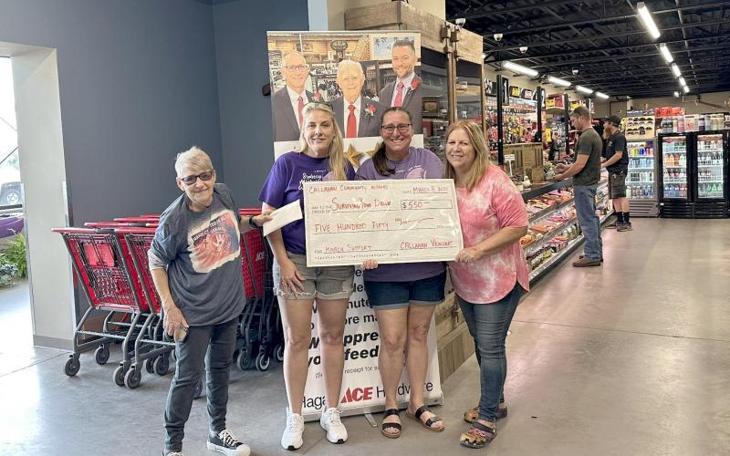 Surviving Your Drive President Sherry Weiscopf and Secretary Mary Lockwood accept a $550 donation from Sherry Taylor and Alice Jones, who represent the Callahan Community Market.