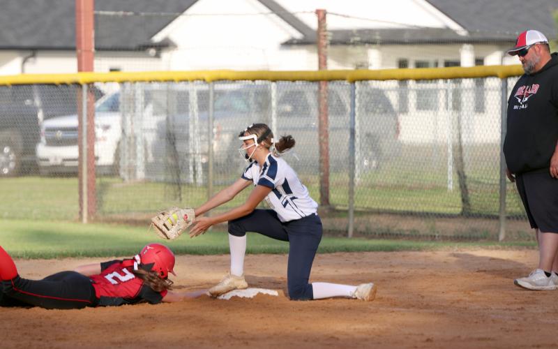 Lady Rambler Ellie Page attempts to tag Hilliard’s Janelle Geoghagan at first base April 10.