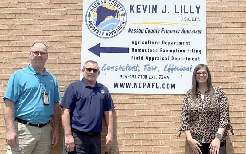 Nassau County Property Appraiser Office employees Tim Williams, Will Wood and Samantha Brandt assist residents at the Callahan office. New extended hours begin Monday in an effort to better meet citizens’ needs. Submitted