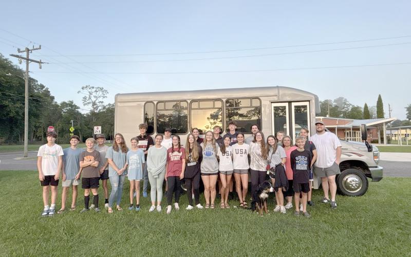 Youth from First Baptist Church Hilliard prepare to board the bus for Camp Clarity Monday.