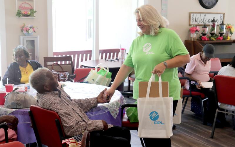 FPL External Affairs Manager Carol Saviak presents Hilliard senior Sylvester Ross with a meal kit at the Westside Senior Life Center June 18. The kits were distributed to senior citizens to help them prepare for the hurricane season, which continues through Nov. 30.