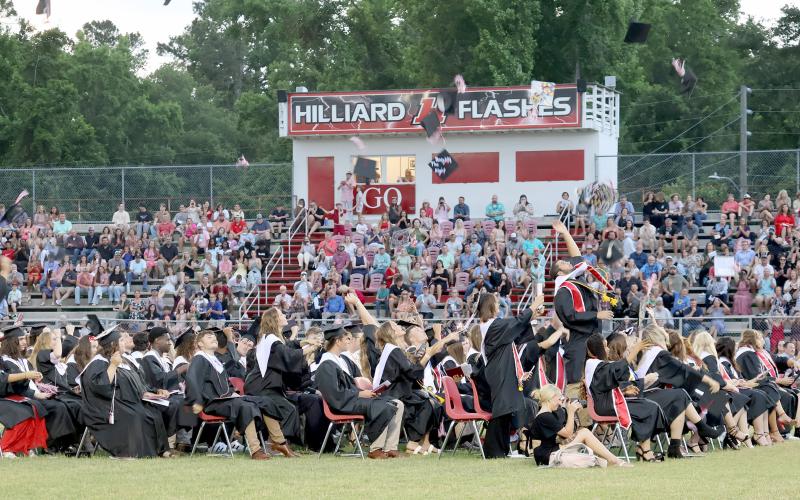 Graduates throw their caps in the air at Hilliard Middle-Senior High School May 27.