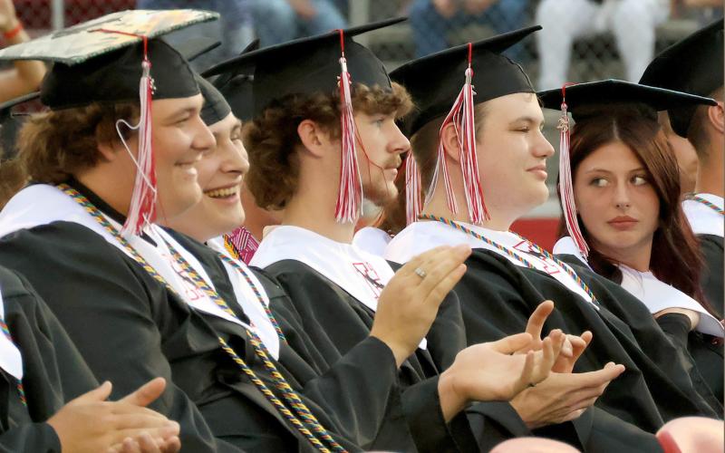 Blake Ray, Emmanuel Olivencia-Christensen, Fisher Monds, Sebastian Modica, and Abigail Miller clap for fellow graduates.