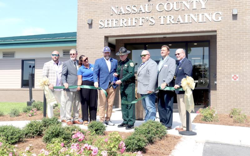 Nassau County Sheriff Bill Leeper cuts the ribbon Monday for phase two of the Nassau County Public Safety Training Complex. He is joined by U.S. Rep. Aaron Bean, Nassau County commissioners Klynt Farmer, Alyson McCullough, Jeff Gray, A.M. “Hupp” Huppmann, John Martin, and Nassau County Manager Taco Pope.