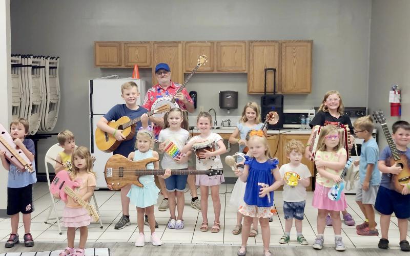 Children explore musical instruments with Joel Pace in Callahan June 16.
