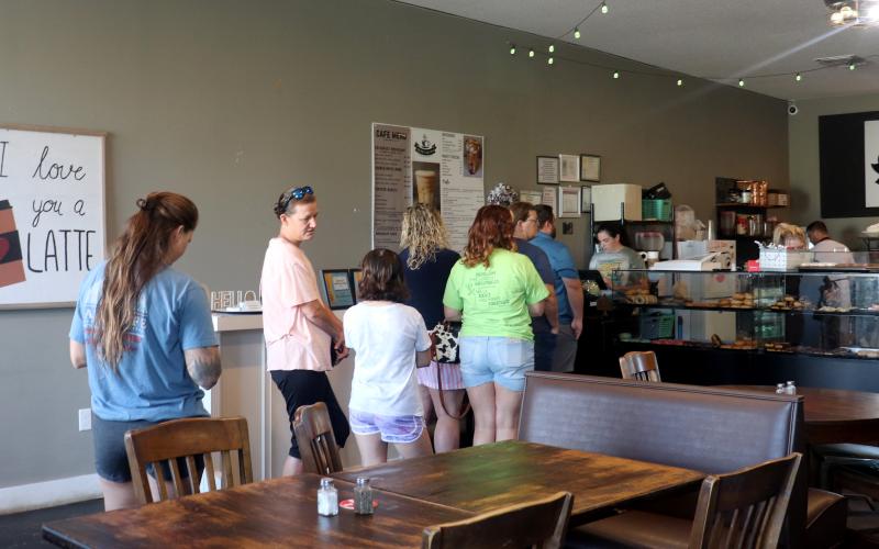 Customers wait to order at Sweet As Cyn Coffee House and Donuts Friday. Sweet as Cyn received $1,600 in donations from local business to pay it forward to customers.