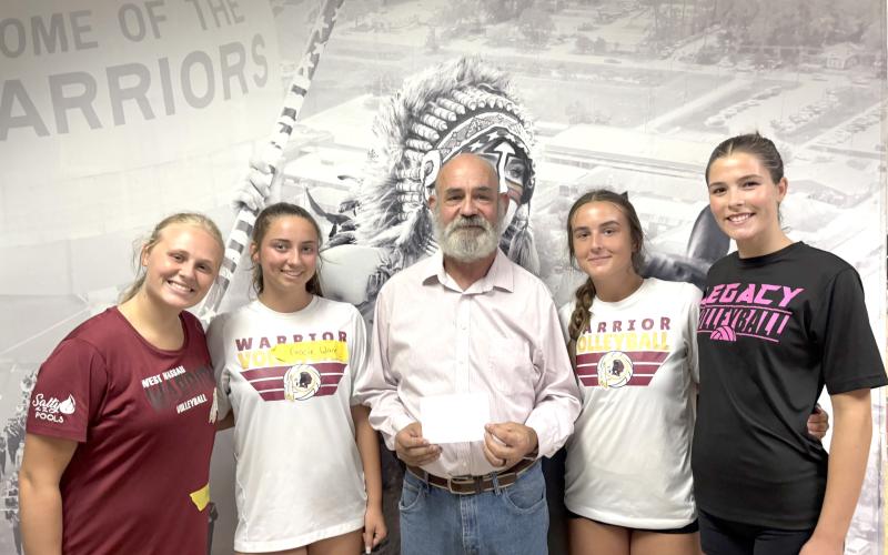 West Nassau High School volleyball teammates Kaycie Turner, Gracie Ware, Parker Madden and Skylar Thien present Don Nichols with a donation to the Callahan Masonic Lodge’s Angel Tree program.