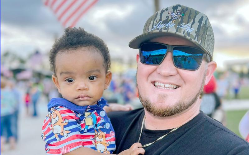 Youth Pastor Ethan Thompson holds Isaiah, who will be a year old Saturday.