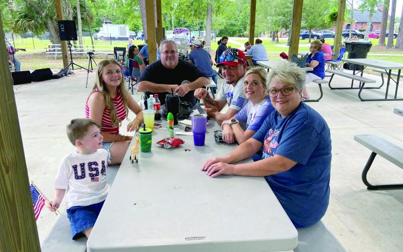 Mayor John Beasley joins family members at top while numerous golf cart owners decorated their rides in patriotic colors before hitting the streets of Hilliard to celebrate America.