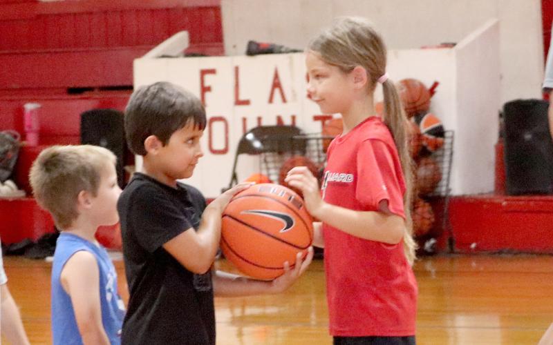 Tynlee Carmichael hands Drake Thompson the ball. Photos by Anna Newhoff