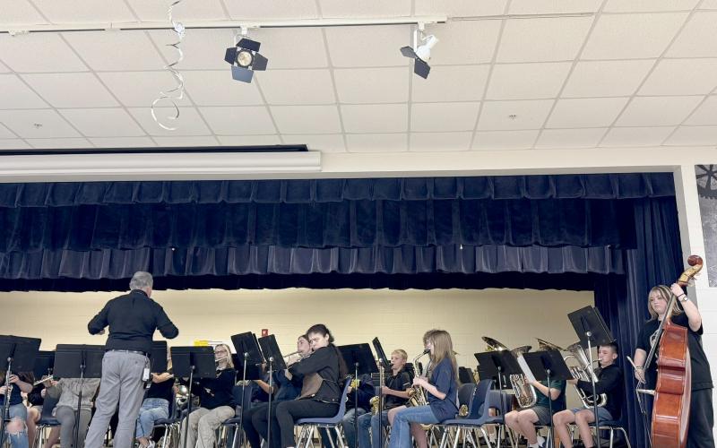 Nassau Education Foundation Executive Director Susan Devane (left) and ARIAS President Sheri Van Orden present Callahan Middle School Band Director Paul Arnold a grant for individual portable tuning devices for members of the school’s band.