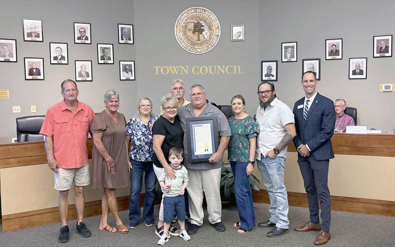 Hilliard Mayor John Beasley is joined by his family, including wife Donna, and Florida League of Cities Director of Member Services and Training Chris Holley Thursday night. Beasley has spent 25 years as a public servant, first elected Nov. 7, 2000. He currently acts as mayor of the town. Photo by Alicia Head