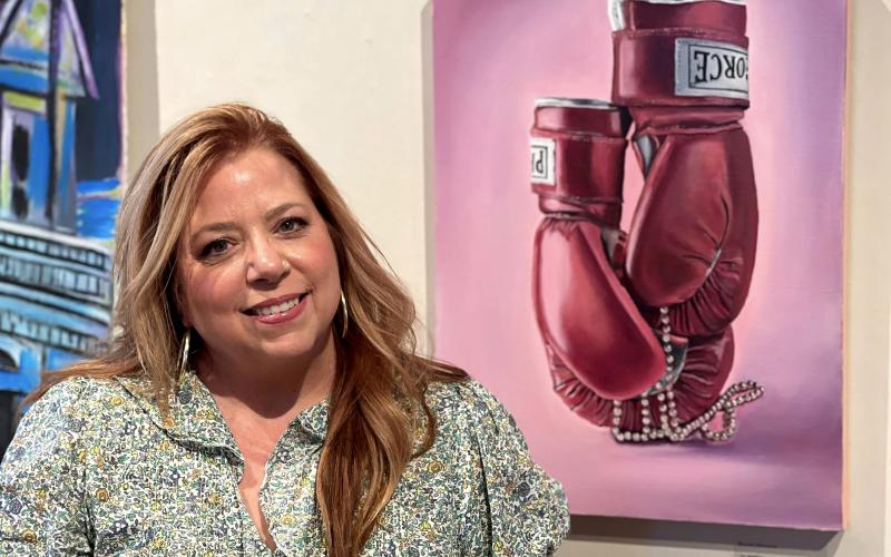Brenda Schwend stands by her painting “I am speaking.” Her show opened Tuesday in the Kent Campus Gallery of Florida State College at Jacksonville. Submitted