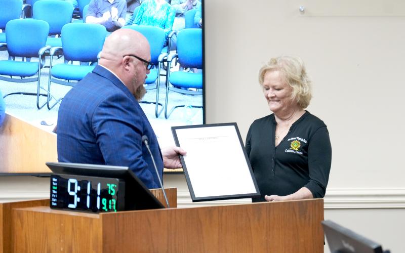 District 5 Nassau County Commissioner Klynt Farmer presents a proclamation to Northeast Florida Fair Association Vice President Paulette Kirkland in support of a funding request via the Florida Department of Agriculture and Consumer Services for an Agriculture Education and Promotion Facility grant.