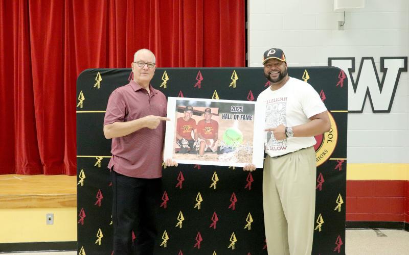 Raymond Fachko and Russell Palmer, Jr., hold a photo of David Crosby. All three of them were inducted into the West Nassau High School Hall of Fame Friday night