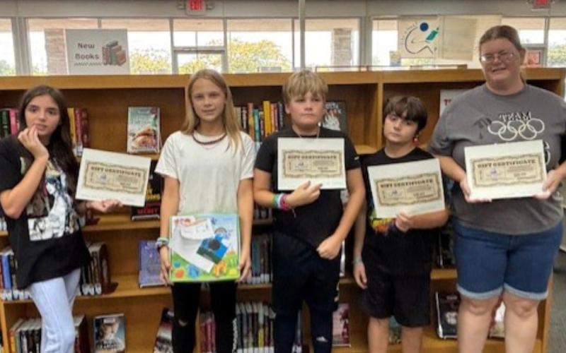 Numerous prizes are collected at the end of the Nassau County Public Library’s “Color Our World” summer reading program.