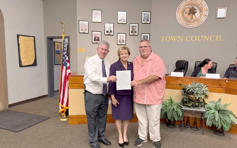 Hilliard Mayor John Beasley stands with Emily’s Promise President Doug Adkins and Vice President Janet Adkins. He read a proclamation in honor of the town naming October as Emily Adkins Blood Clot Awareness Month. The Adkins aim to raise awareness and help stop preventable blood clot related deaths. Photo by Anna Newhoff