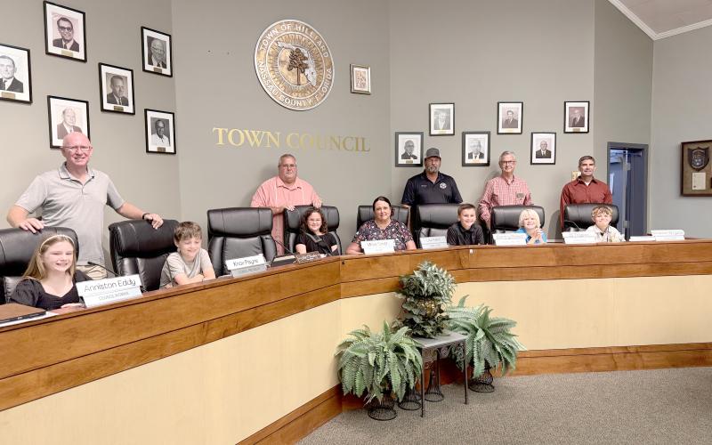 The fifth-grade mayor and council members join Hilliard Town Council members Dallis Hunter, Lee Pickett, Joe Michaels, and Jared Wollitz, Mayor John Beasley, and Town Clerk Lisa Purvis. Photo by Anna Newhoff