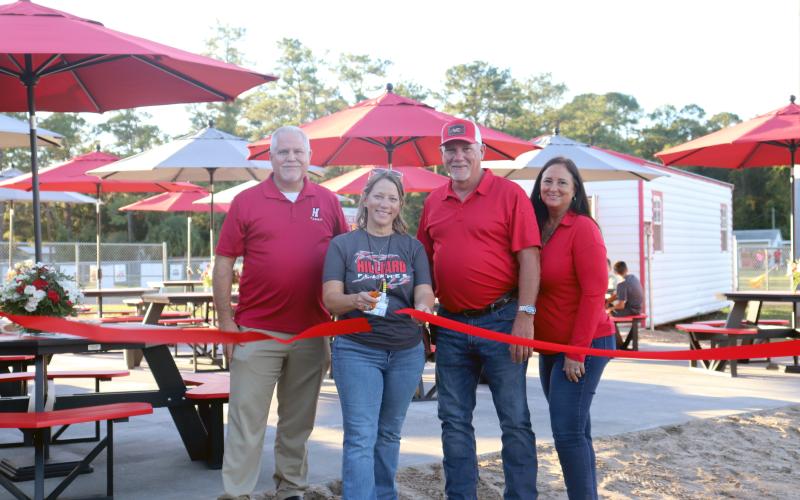 Hilliard Middle-Senior High School art teacher Heather Cash-Canode cuts the ribbon to open the new Alumni Art Courtyard Friday evening. Joining her are Principal John Crawford and Walnut Creek Furniture owners Gene and Treana Jackson. Photos by Anna Newhoff