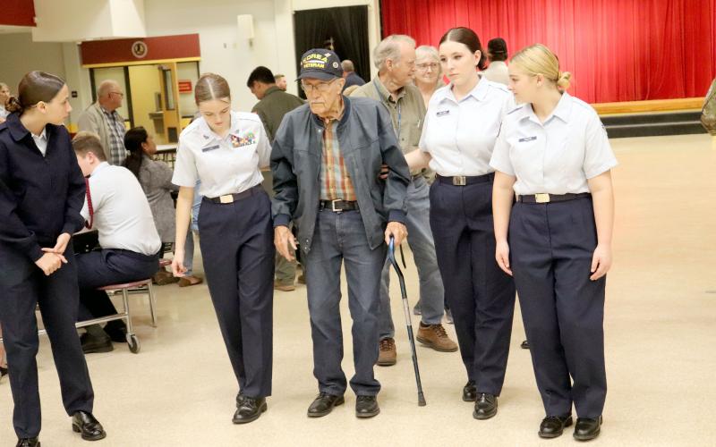 U.S. Navy Korean Conflict veteran Waldo Romero, Sr. of Hilliard is escorted by West Nassau Air Force Junior ROTC Flight 955 cadets during the Veterans Appreciation Dinner Thursday evening. View more photos of the event on page 3. Photo by Amanda Bishop