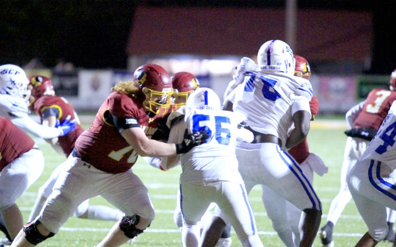 Junior Clayton Lee blocks for the Warriors Friday night. West Nassau won 48-12 to advance to the second round of the postseason.