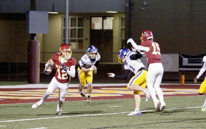 Sophomore defensive back Josh Stafford takes possession of the ball at left.