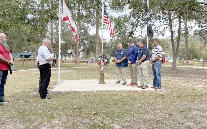 U.S. Rep. Aaron Bean visits with area residents at the Town of Hilliard’s Veterans Appreciation Ceremony Saturday morning. Bean spoke about respect for the sacrifices and services the veterans provided Americans by serving in the military. Submitted