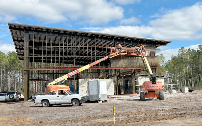 The contractor installs knotwood siding on the airnasium at the Westside Regional Park. The first phase of the park should open in early summer.