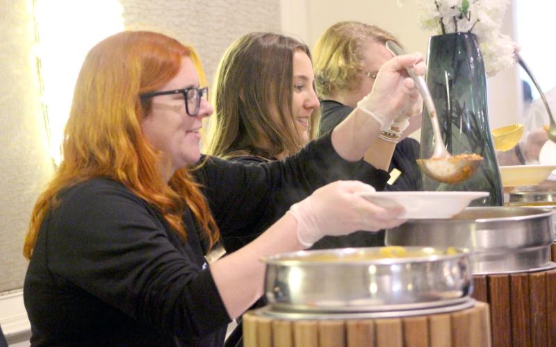 Bowls of soup are served up during Barnabas Center’s 12th annual Empty Bowls event Nov. 25. The event raised $50,000, including the online auction of several locally hand-painted bowls, pictured above right. Photos by Marisa DeMar