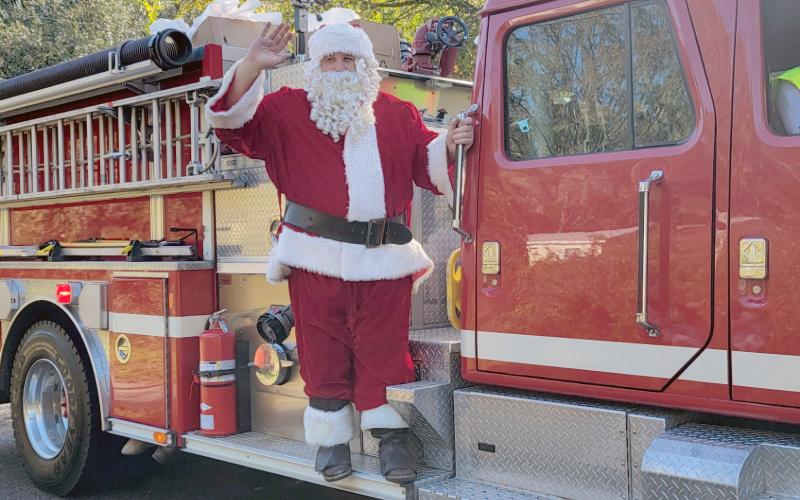 Santa rides on a Hilliard fire truck in 2024 and will climb aboard again this Saturday. Photo by Amanda Bishop