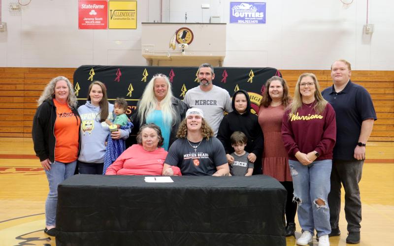 West Nassau High School senior Brian Wheat signs with Mercer University Dec. 3, with friends and family attending the celebration.