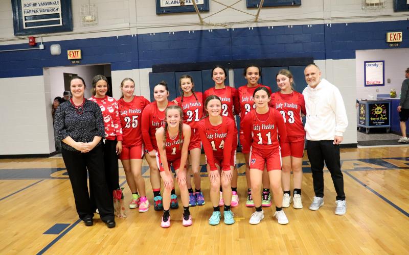 The Hilliard Middle School varsity girls join together with their coaches after winning the school’s fourth county championship in a row. View more photos on page 11. Photo by Amanda Bishop