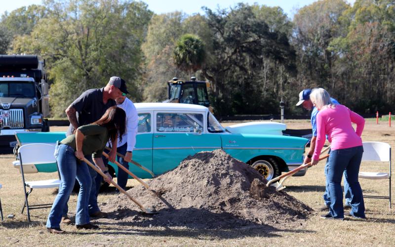 David and Lisa Hicken break ground Dec. 23 at the Hicken Power Drag Strip as Nassau County business owner Heather Hagan and Southern Rail Construction workers Donald Goff and Dwayne Kirchner join them. The Hickens speak to those in attendance at top. The drag strip will be located behind the oval race track already in place on the property, which is located at 543455 U.S. 1, Callahan. Photos by Anna Newhoff