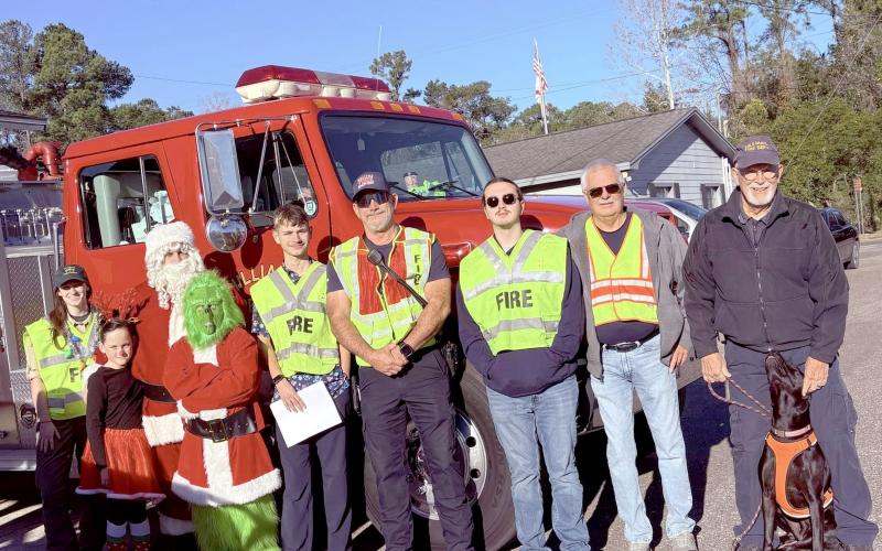 Volunteer firefighters with Hilliard Station 4 help Santa Claus spread holiday cheer throughout town Saturday morning.