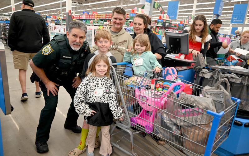 Students from Bryceville Elementary School, Call-ahan Elementary School, and Callahan Intermediate School shop with deputies from the Nassau County Sheriff’s Office Dec. 4 during the annual Shop with a Cop event.