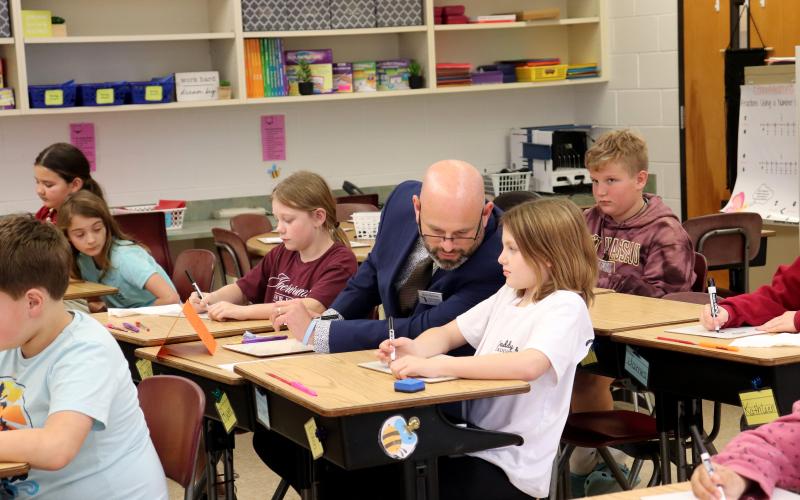 Florida Teacher of the Year Mark Harrison participates in a math lesson in teacher Alexis Neu’s fourth-grade class Thursday afternoon. He concluded the day by helping students enter vehicles to head home. Photos by Amanda Bishop