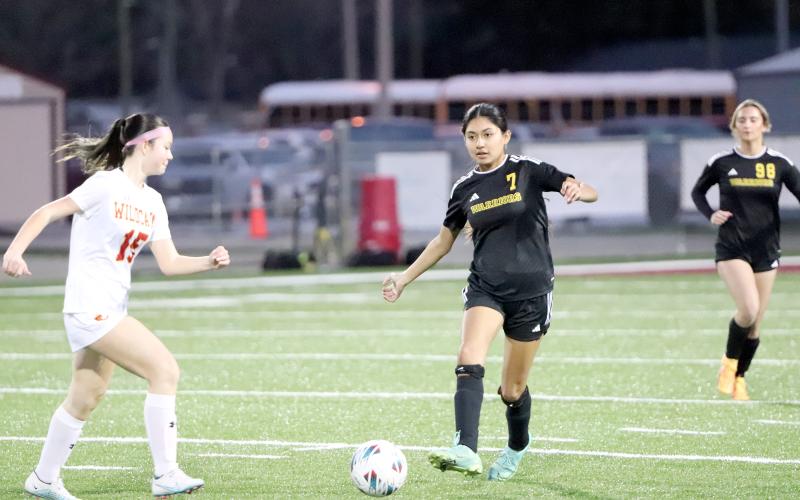 West Nassau’s Brianna Gancerez moves the ball down field as a Lady Wildcat approaches Jan. 13.