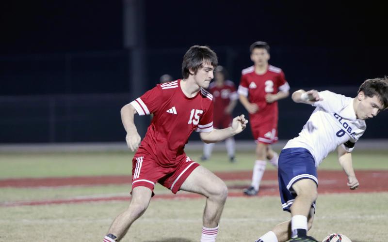 Clayton Floyd tries to get the ball from a Kodiak.
