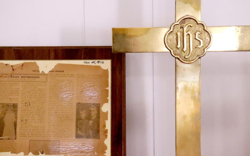 Callahan Methodist Church celebrates its 140th anniversary with a display of artifacts and pictures. A cross was placed by a 1912 newspaper clipping, showing the historical significance of the church through the years. Photo by Anna Newhoff