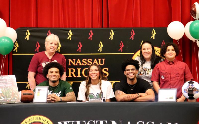 West Nassau High School senior Danyelle Bell is joined by mom Sarah Monds, grandmother Ellen Monds, and brothers Chaz Davis, Prentiss Davis, and Brisyn Holmes as she signs with Mercyhurst University March 9.