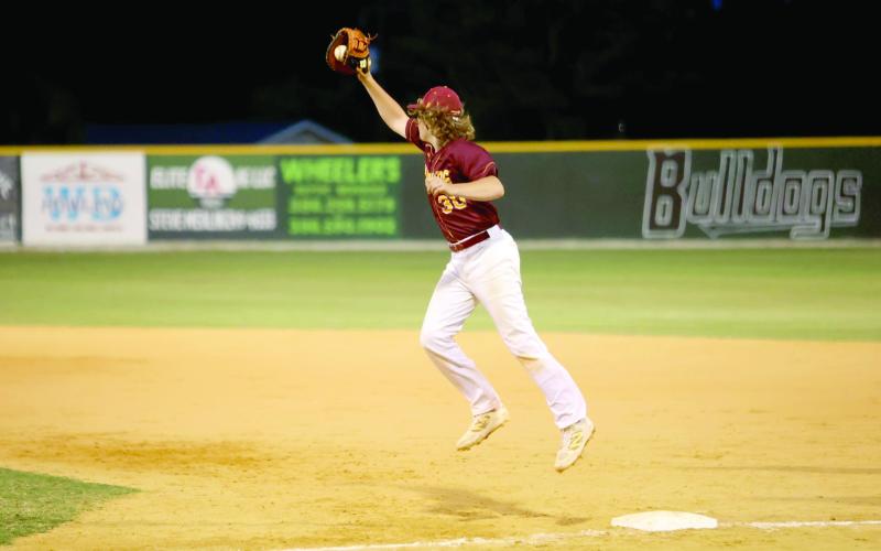 Liam Reeves catches a high throw at first base.